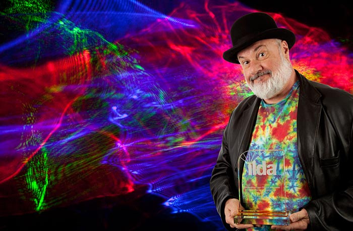 Laser Artist Mike Gould holding his 2013 ILDA award